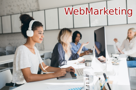 joyful-african-web-developer-working-on-new-project-while-listening-music-in-white-headphones-black-female-designer-doing-her-job-in-office-with-talking-colleagues joyful-african-web-developer-working-on-new-project-while-listening-music-in-white-headphones-black-female-designer-doing-her-job-in-office-with-talking-colleagues